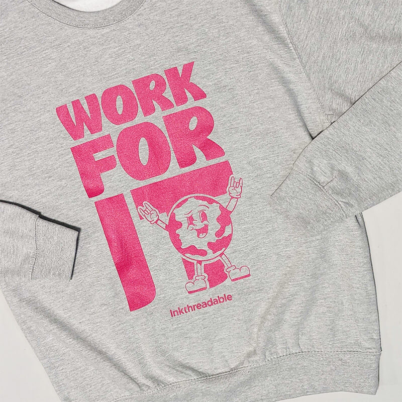 close up shot of a hot pink DTG print on a heather grey sweatshirt